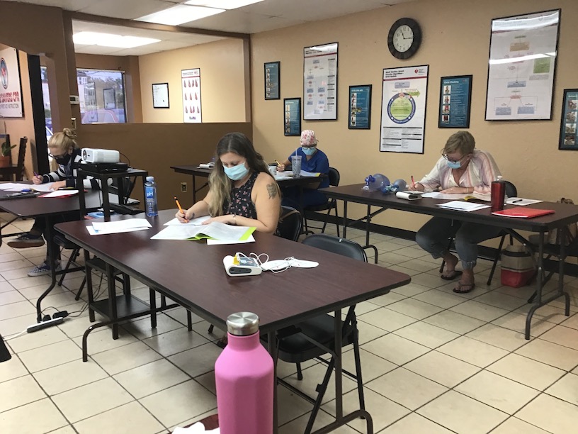 four people with masks taking first aid training test tampa bay st pete area